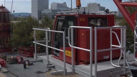 A big red crane preparing an old ship for repairs at the shipyard Video stock 120989357