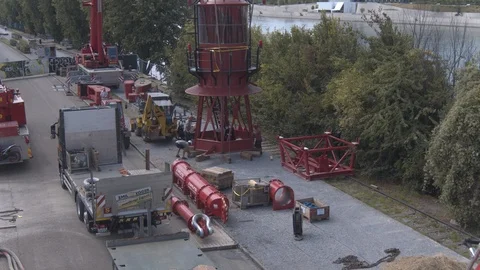 A big red crane preparing an old ship for repairs at the shipyard Stock Footage 120989445