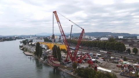 A big red crane preparing an old ship for repairs at the shipyard Stock Footage 120991025