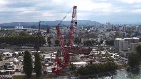 A big red crane preparing an old ship for repairs at the shipyard Stock Footage 120993222