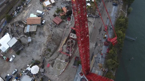A big red crane preparing an old ship for repairs at the shipyard Stock Footage 120993323