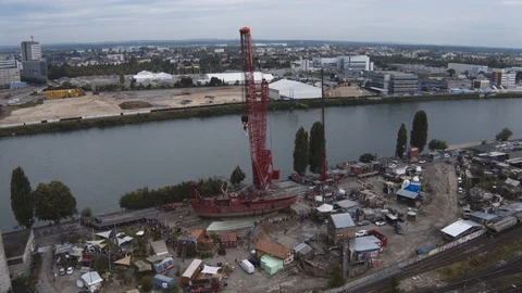 A big red crane preparing an old ship for repairs at the shipyard Stock Footage 120994090