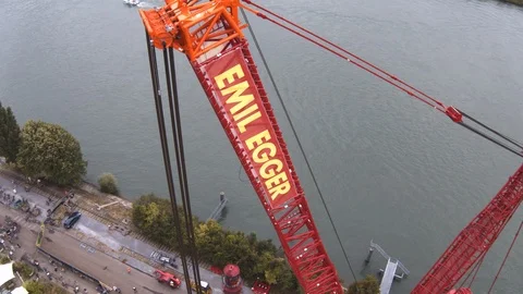 A big red crane preparing an old ship for repairs at the shipyard Video stock 120994320