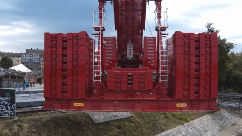 A big red crane preparing an old ship for repairs at the shipyard Stock Footage 120994492