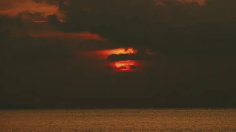 Big red dramatic sun in dramatic clouds, tropical sunset Stock Footage 330873102