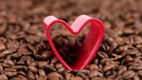Big red heart on roasted coffee beans. The concept of coffee adoration. Stock Footage 245086967