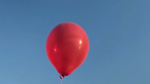 Big red hot air balloon flies against the blue sky Stock Footage 154350082