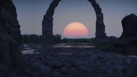 Big red setting sun visible through stone portal or gate. Fantasy landscape at Stock Footage 135227732