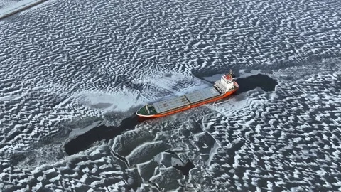 A big red ship frozen in the endless sea of ice. Aerial View Stock Footage 236489787