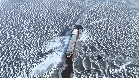 A big red ship frozen in the endless sea of ice. View of dead frozen harbour Stock Footage 238942784