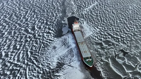 A big red ship frozen in the endless sea of ice. View of dead frozen harbour Stockbeeldmateriaal 239351368