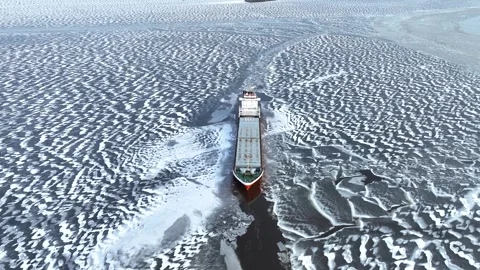 A big red ship frozen in the endless sea of ice. Aerial View of dead frozen Stock Footage 240230746
