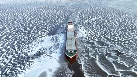A big red ship frozen in the endless sea of ice. Aerial View of frozen harbour Stock Footage 301201676