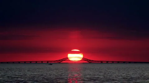 Big Red Sun Setting Over Bridge with Boat Video stock 924195