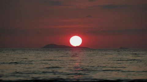Big red sun touching horizon over tropical sea Stock Footage 331062852