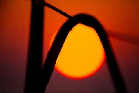 Big red sun under sailing ropes and lifeline silhouette Stock Photos