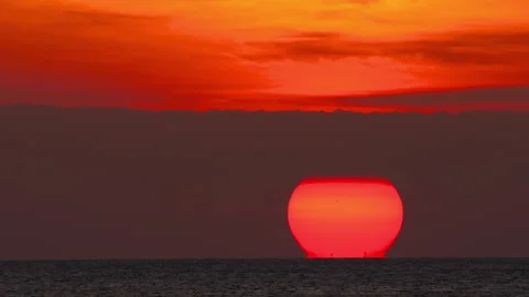 Big red sunset sun setting into ocean horizon timelapse Stock Footage 336188752