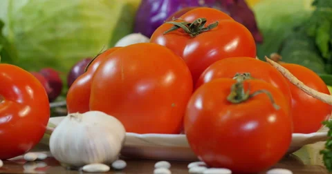 Big red tomatoes on table, dolly shot on left,fresh vegetables,close up. Stock Footage 60604020