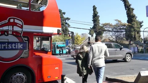 Big, red tourist bus opens up view to the intersection Stock Footage 95923665