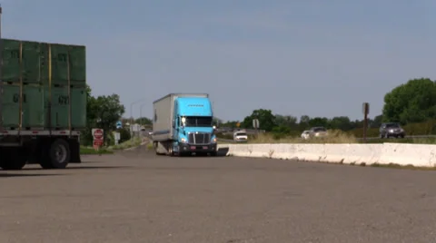 Big rig semi trucks, interstate 5, blue truck turning Stock Footage 37254664