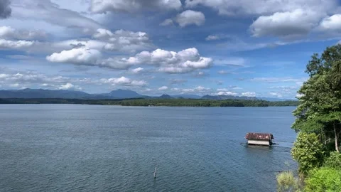 Big river and clear sky.A small house on a big river. Stock Footage 278331345
