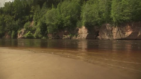 Big river in forest with cliffs at the banks in sunny summer day Stock Footage 159981446