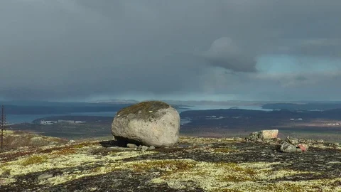 A big rock on a mossy plain against a cloudy sky. Stock Footage 76102264
