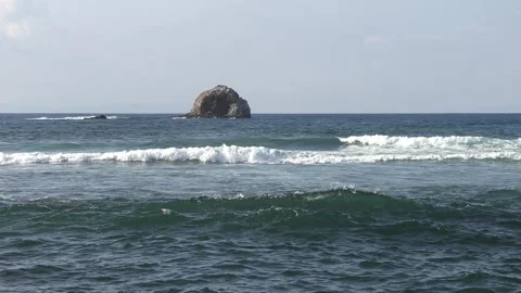 Big rock in ocean with big waves Stock Footage 252987483
