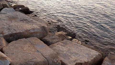 Big rock with waves and sunset Stockbeeldmateriaal 297645347