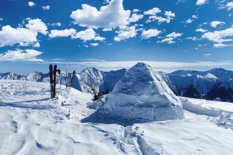 Big round igloo stands on mountains covered with snow attracting the passing by Stock Photos
