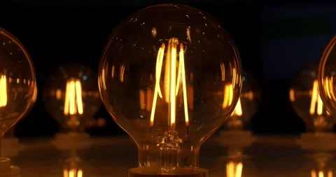 Big round light bulb with yellow filaments in retro style for lighting Vídeo Stock 277348698