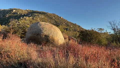 Big round rock (boulder) at sunset at the hills of Southern California Stock Footage 217400593