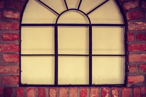Big rounded window on red brick wall Stock Photos