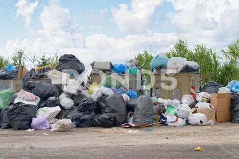Big rubbish dump near the road. Disposal, deterioration and pollution concept Stock Photos