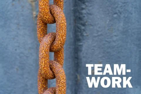 A big rusty chain with the words "Team Work" besides it - Motivation concept Stock Photos