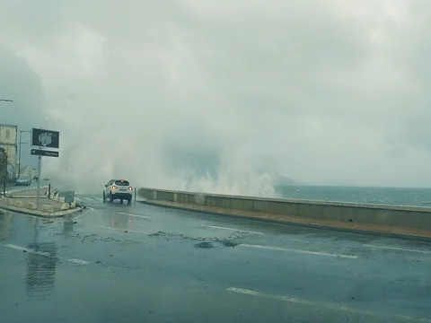 Big Sea Wave Splash Against a Car on City Road Stock Footage 83411141