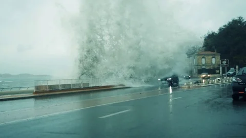 Big Sea Wave Splash Against a Car on City Road Stock Footage 83419442