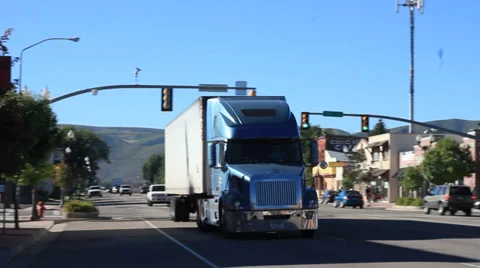 Big Semi truck going down main street Stock Footage 30145992