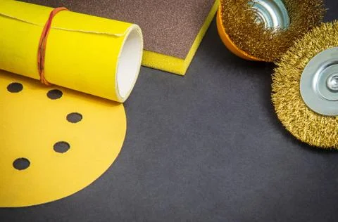 Big set of abrasive tools and yellow sandpaper on black background, wizard is Stock Photos