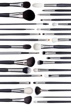 Big set of make-up brushes lined up in alternating pattern. Isolated on white Stock Photos