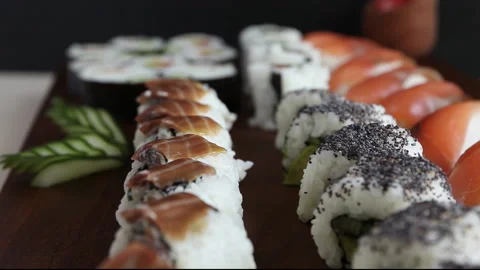 Big set of sushi rolls with salmon, cucumber on the table close-up. Asian food Stock Footage 145437300