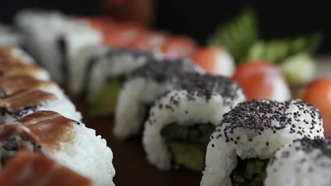 Big set of sushi rolls with salmon, cucumber on the table close-up. Asian food Stock Footage 145437882
