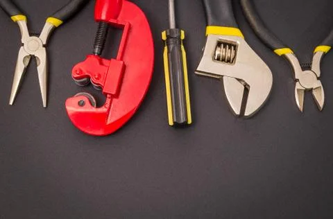 Big set of tools on black background prepared by the master before repair or Stock Photos