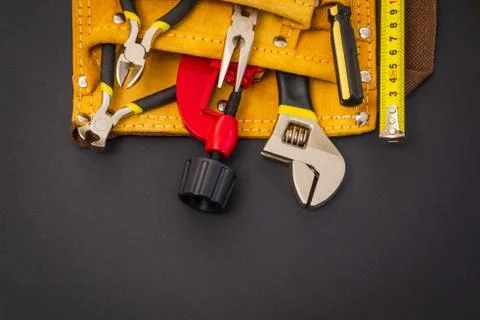 Big set of tools in suede bag on black background prepared by the master befo Stock Photos