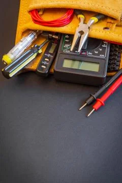 Big set of tools in suede bag on black background prepared by the master elec Stock Photos
