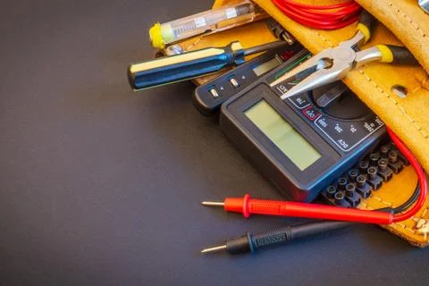 Big set of tools in suede bag on black background prepared by the master elec Stock Photos