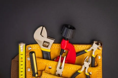 Big set of tools in suede bag on black background prepared by the master befo Stock Photos