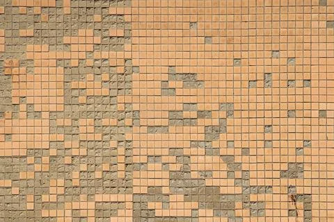 Big shabby textured wall is lined with old Soviet beige crumbling ceramic tiles Stock Photos