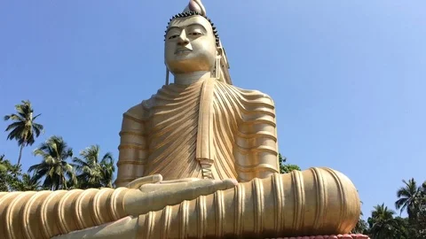 Big shining statue of Buddha in Sri Lanka Wewurukannala Vihara Stock Footage 71607717