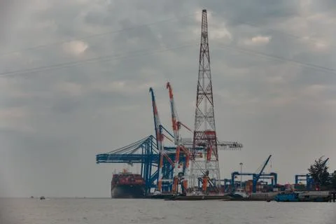 Big ship is loading containers by port cranes in Haiphong container terminal Stock Photos